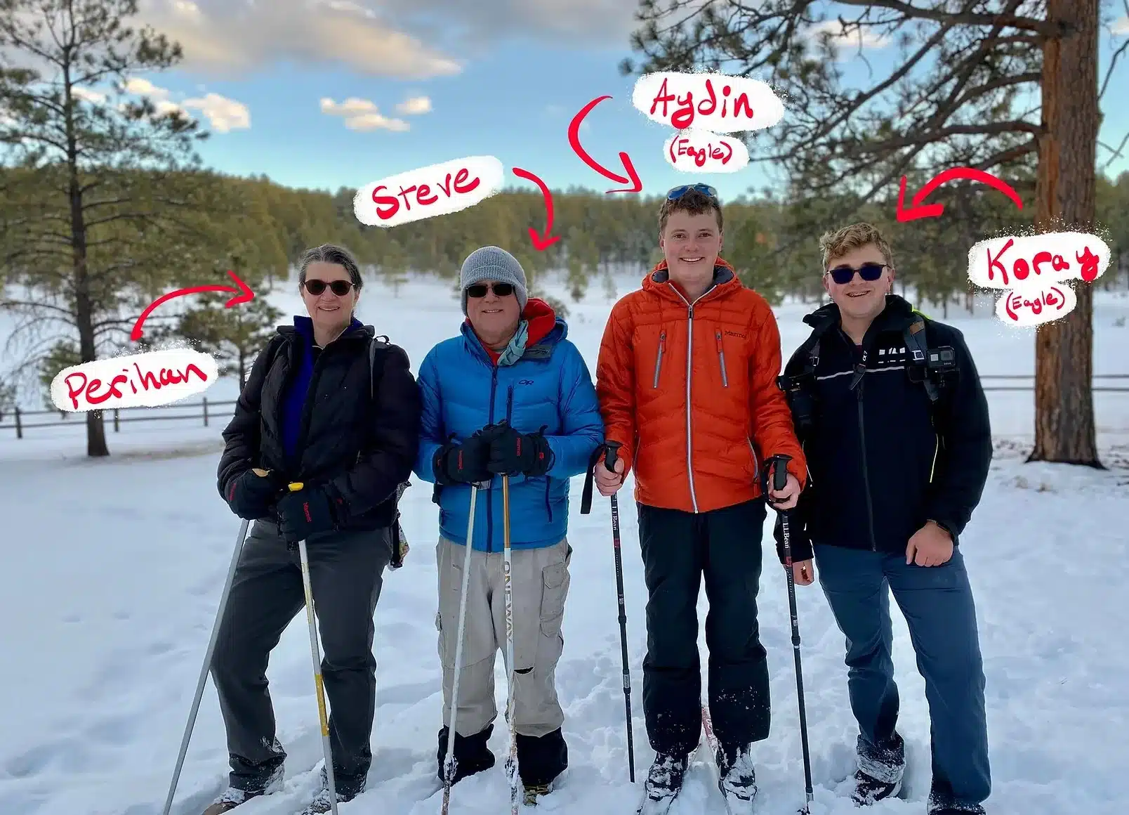 The Gates and Sheard family standing together in the snow among pine trees
