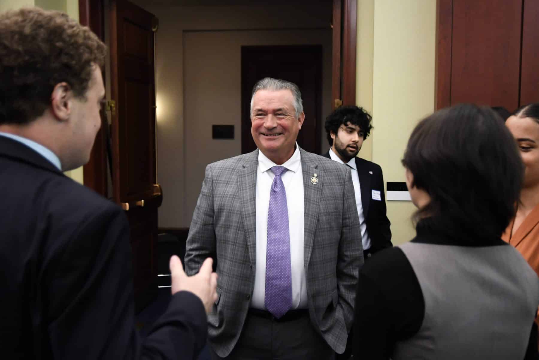 Congressman Don Bacon smiling as he arrives at the reception and greets guests