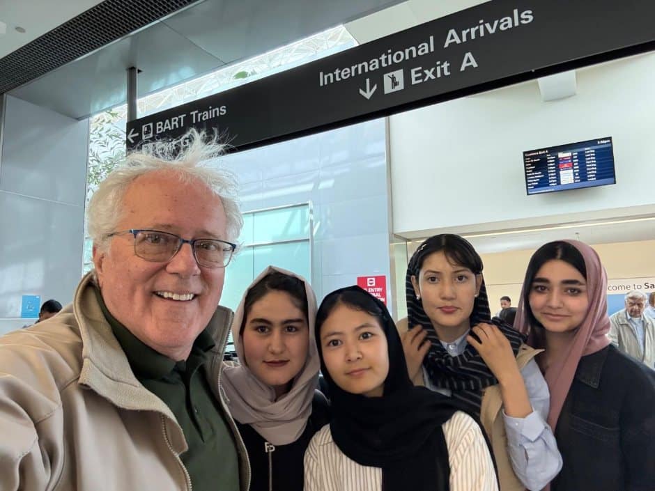 Aydin Gates with four Afghan students at an international arrivals gate