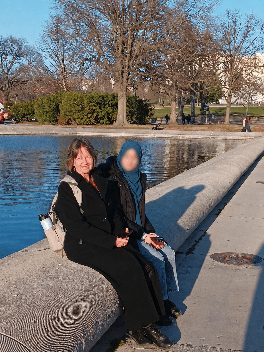 Kirsten Laney with an ASRF student beside a reflecting pool in Washington, D.C.