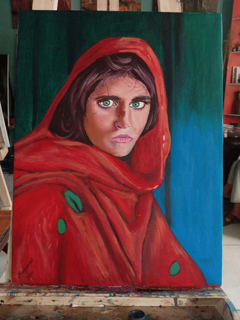Painting of a young woman in a red shawl looking directly at the viewer