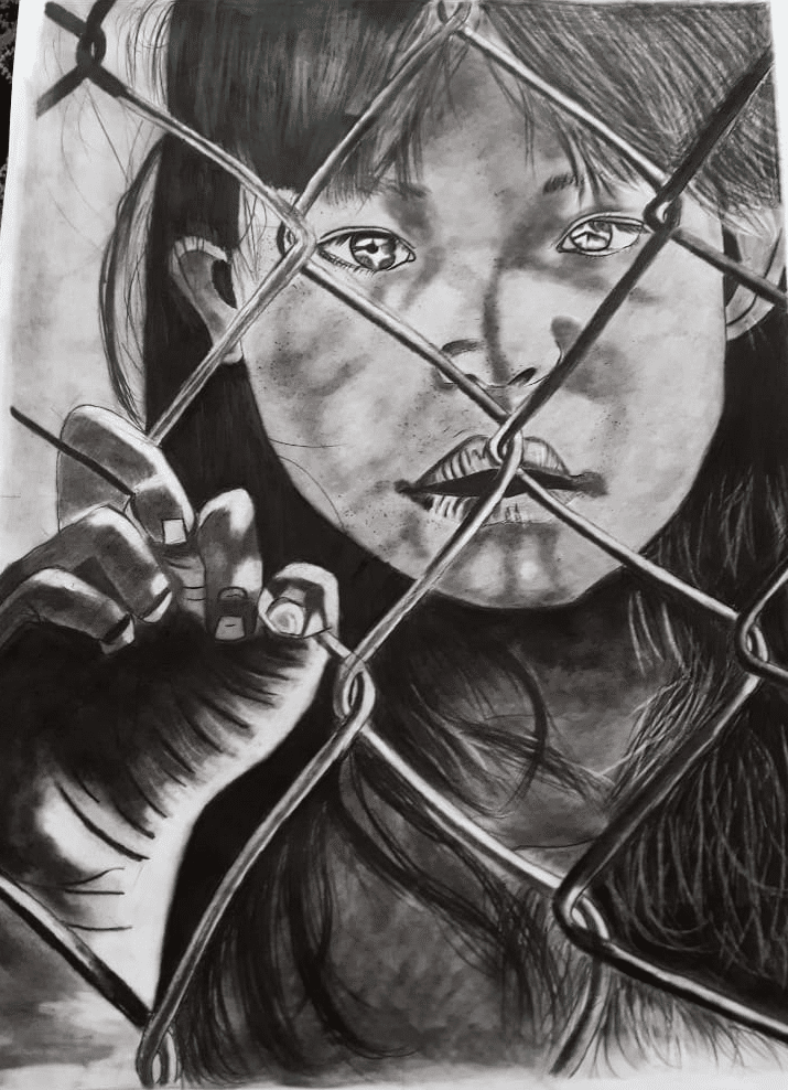 Charcoal drawing of a girl’s face seen through a chain-link fence, one hand gripping the wire