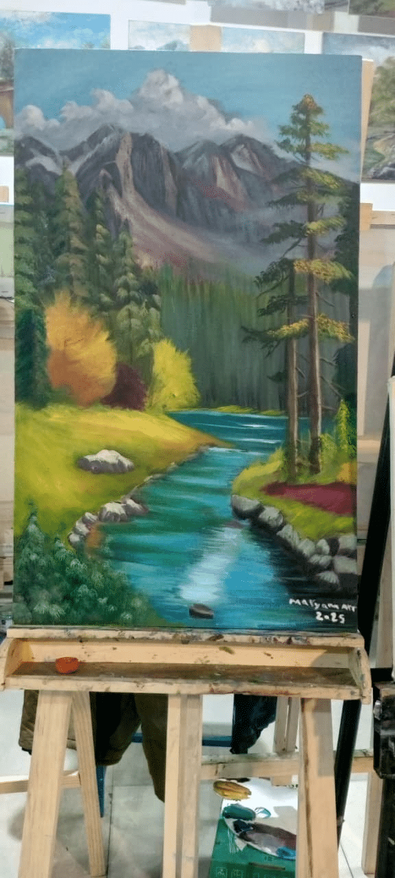 Painting on an easel of a mountain stream running through a pine forest