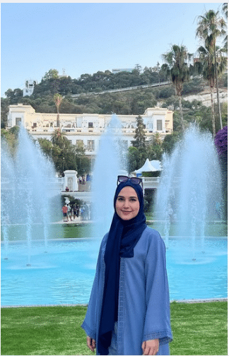 Khaoula Medjedel standing in front of fountains in a park