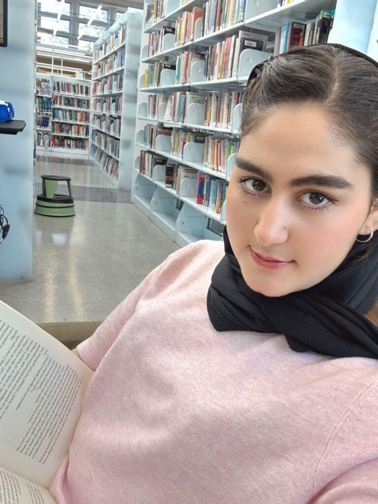 Noorya, an ASRF student, reading in a library